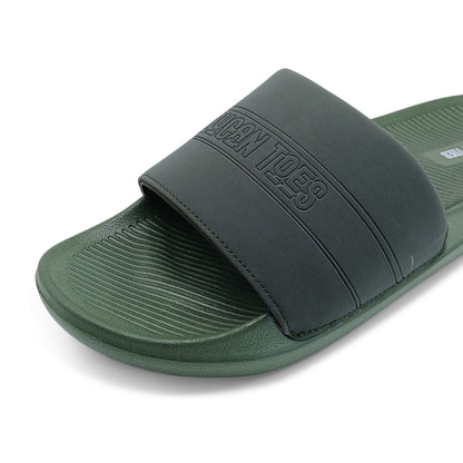 Close-up of green slide sandal with black strap embossed with 'DUNCAN TOES' logo