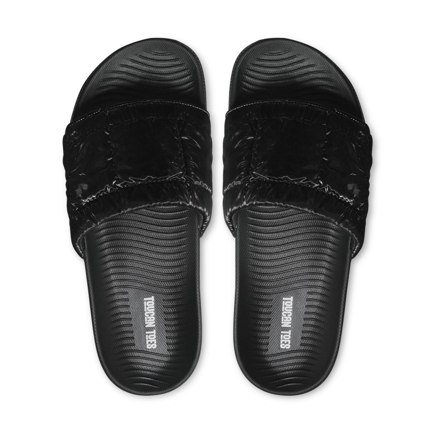 Top view of black cushioned slide sandals with textured footbed and Toucan Toes logo