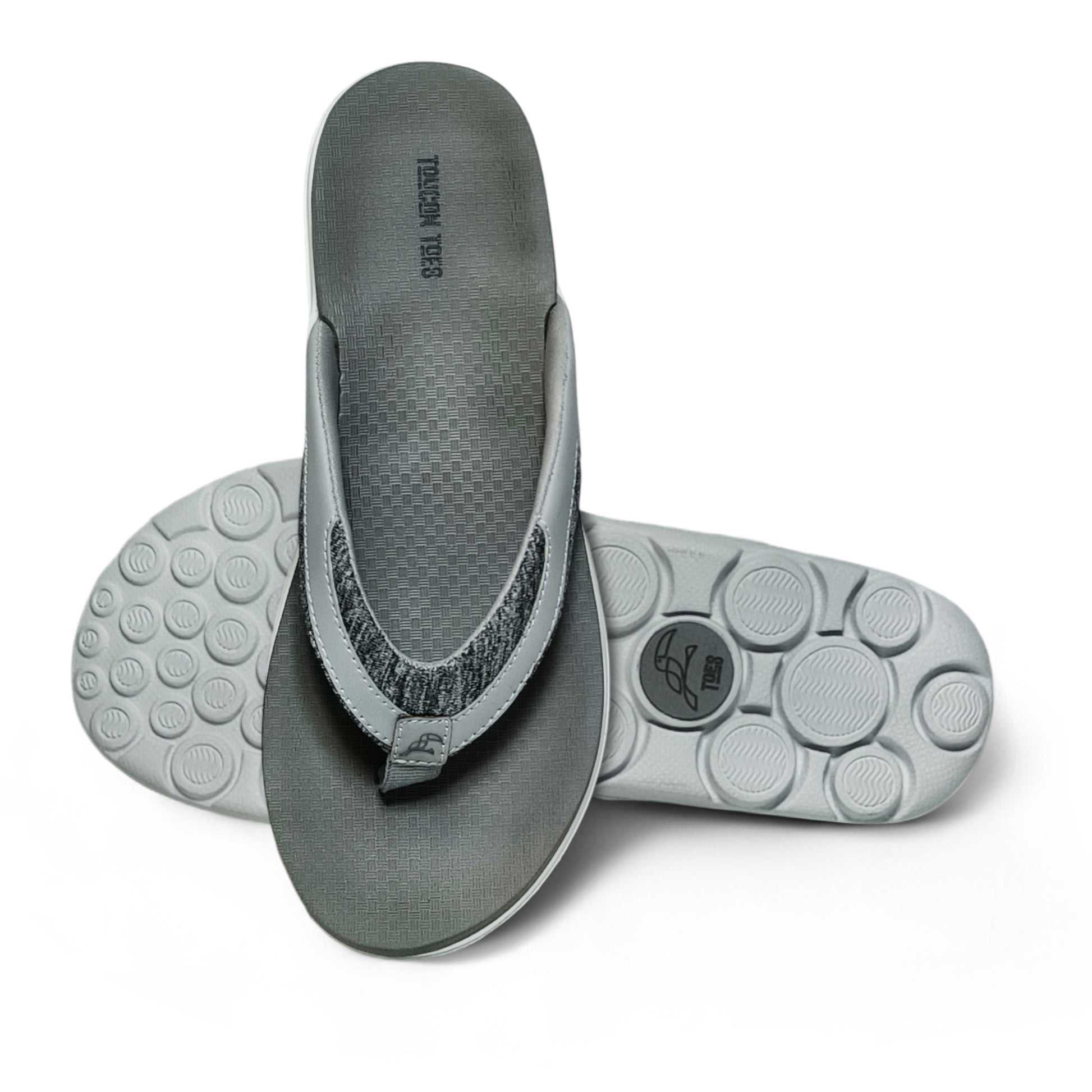 gray cushioned flip flops with textured footbed and circular tread sole on white background