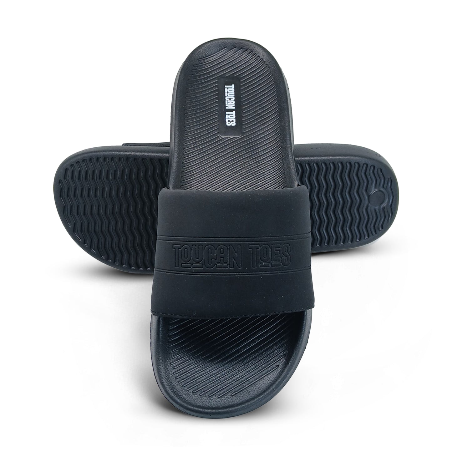 Black Toucan Toes slide sandals with textured footbed and sole on white background
