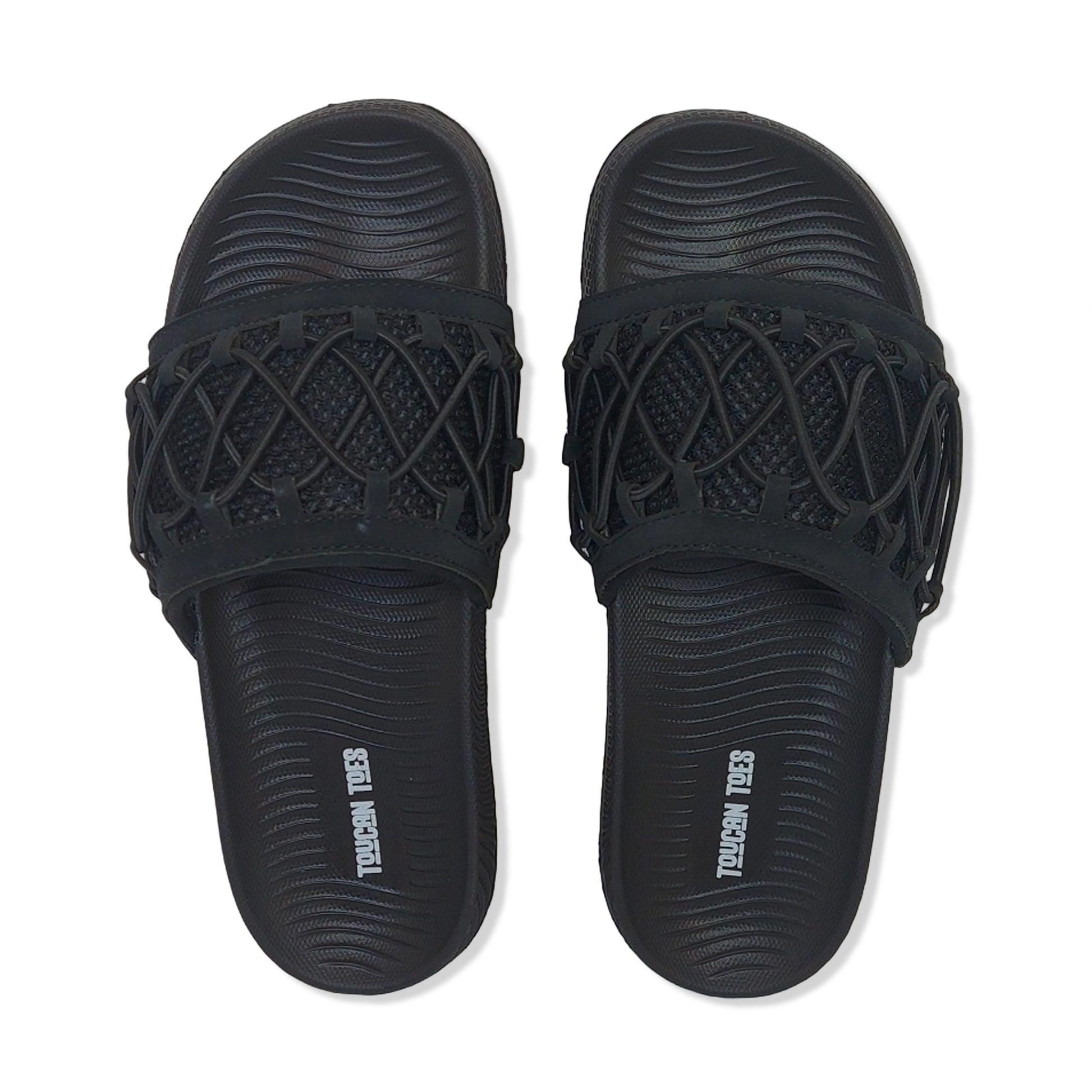 Toucantoes black slide sandals with textured footbed and crisscross strap design.