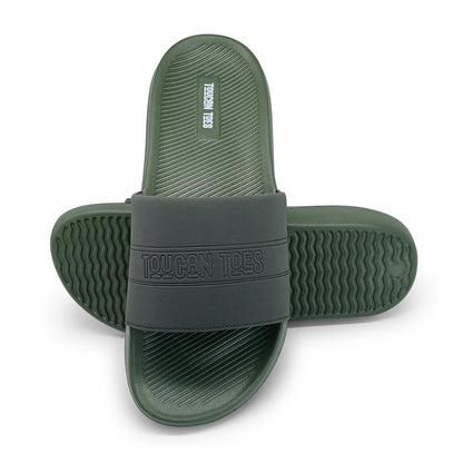 Green and black Toucan Toes slide sandals with textured soles on white background