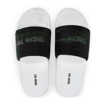 White slide sandals with black straps featuring faded Toucan Toes logo and textured footbed