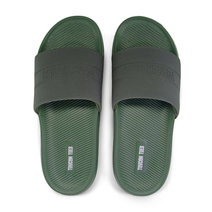 Top view of green and black Toucan Toes slide sandals with textured footbed
