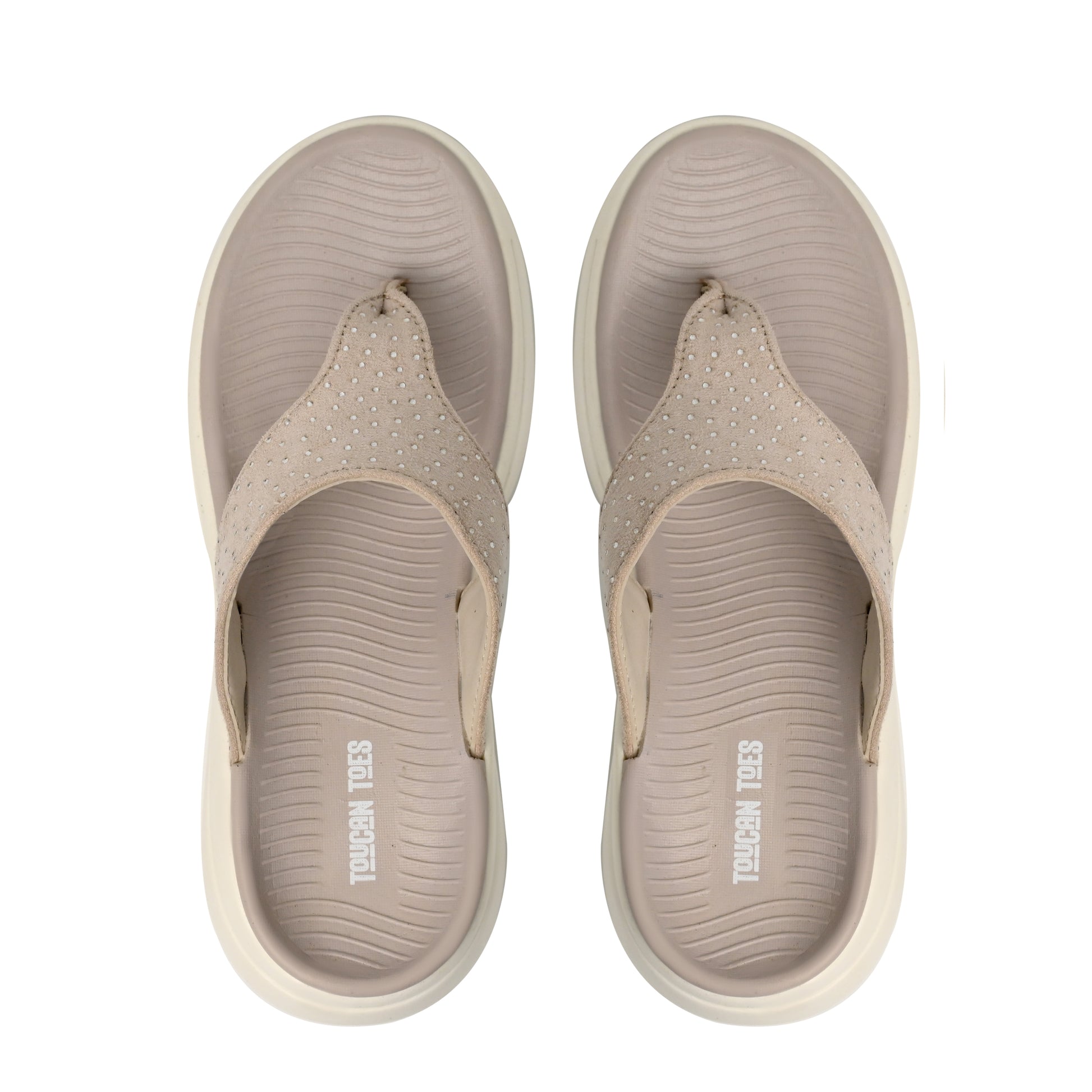 Beige Toucan Toes women’s flip-flops with textured sole and studded straps, top view