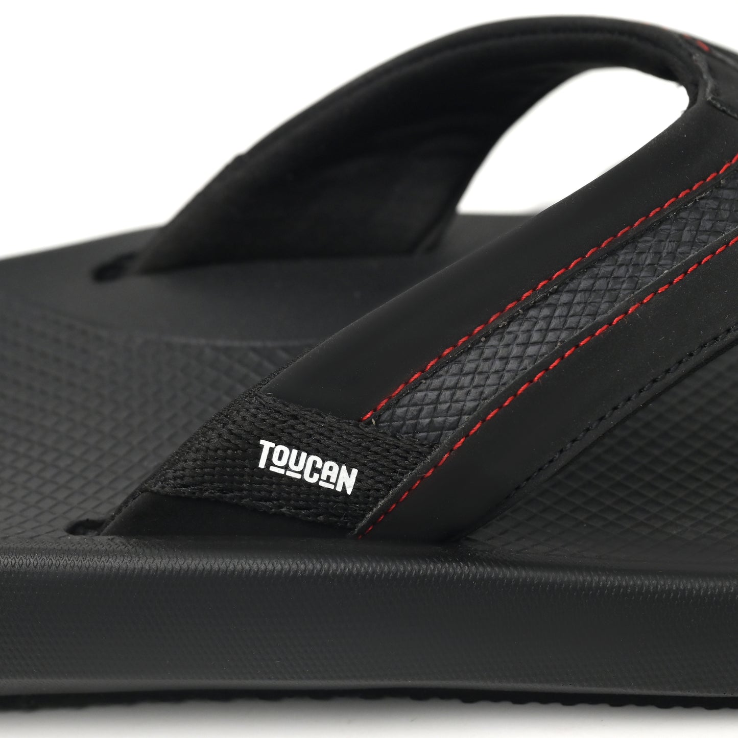 Black Toucan flip flop sandal with textured sole and red stitching details