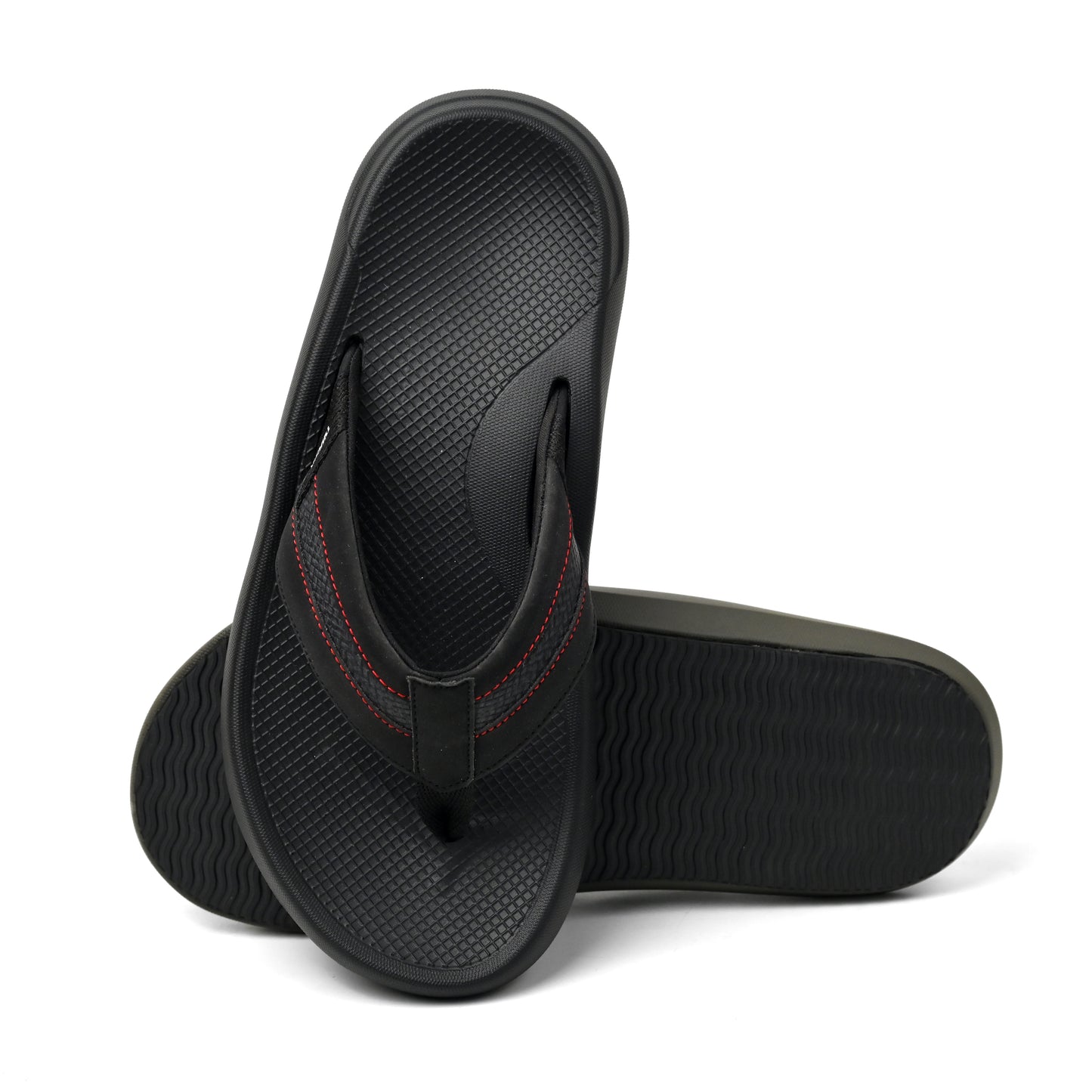 Pair of black flip flops with textured footbed and red stitching on straps, isolated on white