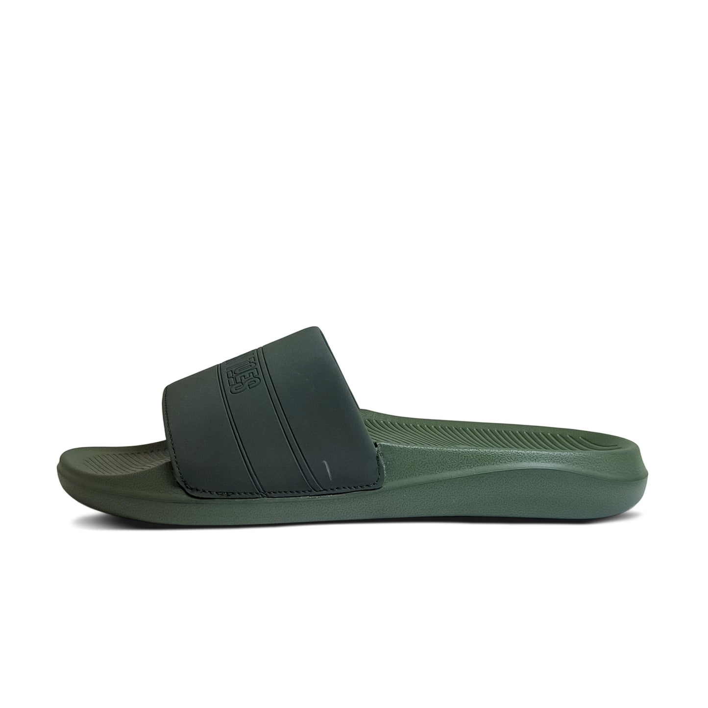 Side view of green and black slide sandal with textured sole and wide strap