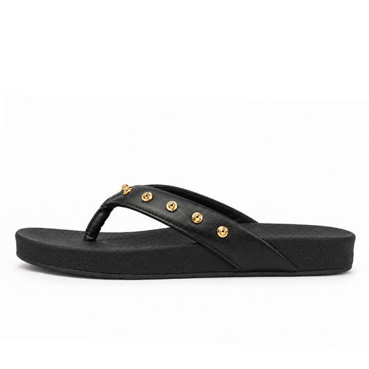 Toucantoes Dome women's flip-flops in black, side view showing the cushioned sole
